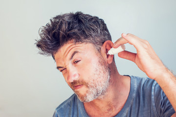 Men using ear drops